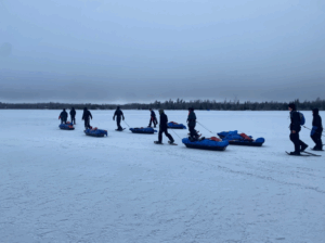 An image of our crew hiking across Flash Lake.