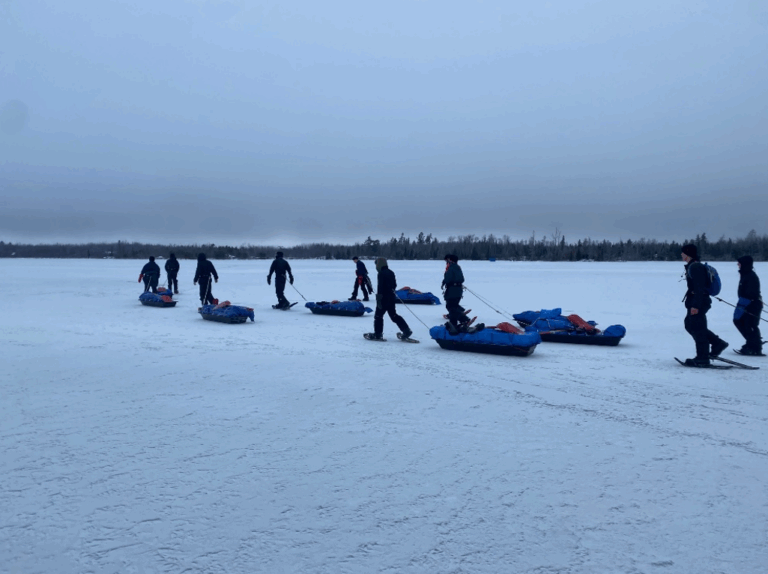 An image of our crew hiking across Flash Lake.