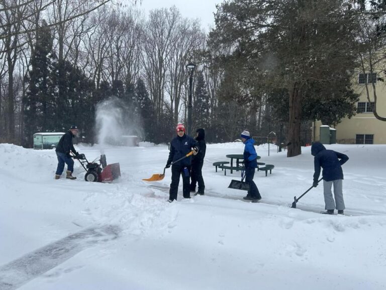 Scouts from Troop 128 clearing snow for their charter organization.