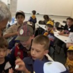 Cubs share their hypotheses for the marshmallow pressurization experiment by Mr. Sokhom Kith.